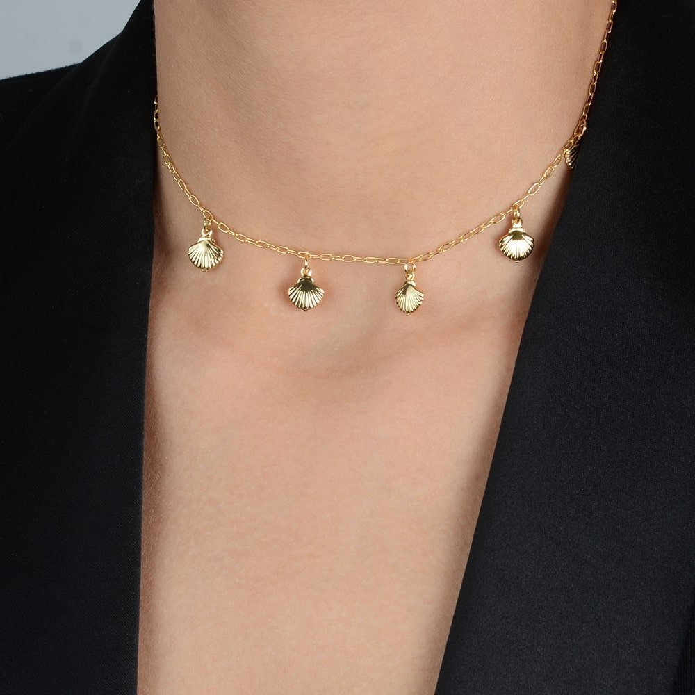 Detalhe do colar dourado Ayren com conchas e acabamento sofisticado