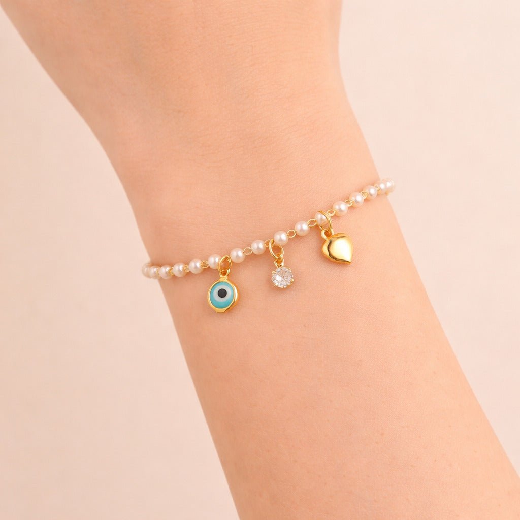 Pulseira Dourada de Pérolas com Olho Grego Coração e Ponto de Luz Auryn - Minha loja
