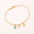 Pulseira Dourada de Pérolas com Olho Grego Coração e Ponto de Luz Auryn - Minha loja